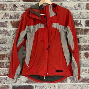 REI Rainjacket - orangey color with lots of interior pockets